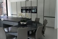 Modern German kitchen design with curved worktop with seats