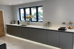 German-Handle-less-Kitchen-with-Island-Tv-Feature-Wall-Titanium-and-Carbon-Quartz-Solid-Surface-1
