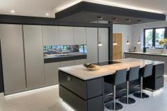 German-Handle-less-Kitchen-with-Island-Tv-Feature-Wall-Titanium-and-Carbon-Quartz-Solid-Surface-3